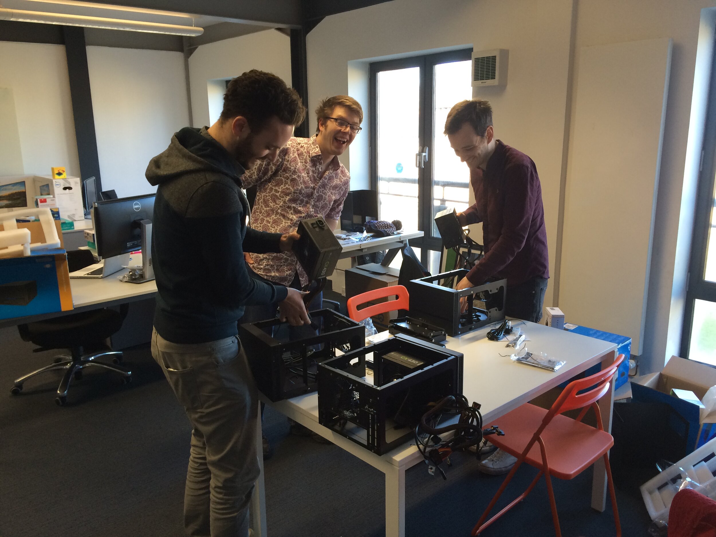 Photo of team members assembling desktop computers